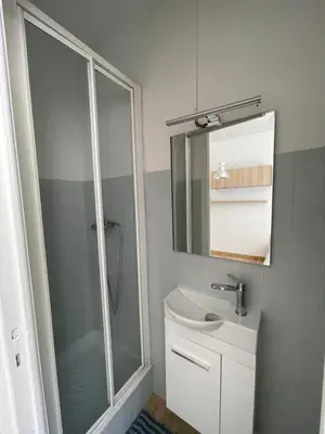 a bathroom with a shower and a sink and a mirror at Studio au coeur de Nice in Nice