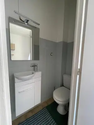 a bathroom with a toilet and a sink and a mirror at Studio au coeur de Nice in Nice