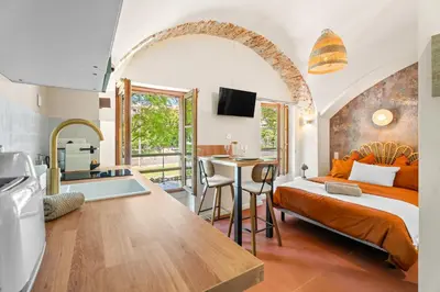 a bedroom with a bed and a kitchen with a sink at Nice Renting - CROTTIb - Studio Rare Pearl Typical Chic Massena & Sea in Nice