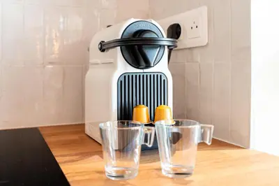 a coffee maker with two glasses on a table at Nice Renting - CROTTIb - Studio Rare Pearl Typical Chic Massena & Sea in Nice