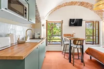 a kitchen with a sink and a table in a room at Nice Renting - CROTTIb - Studio Rare Pearl Typical Chic Massena & Sea in Nice