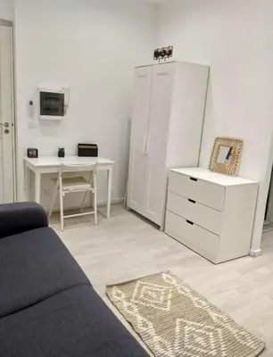 a living room with a couch and a desk and a dresser at Libération - Centre - Charmant Studio Balcon Clim in Nice