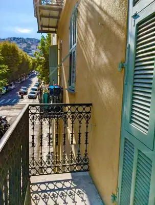 a balcony of a building with a gate and a street at Libération - Centre - Charmant Studio Balcon Clim in Nice