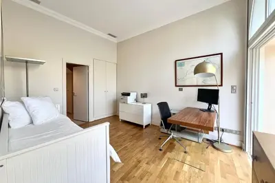 a bedroom with a bed and a desk with a computer at Villa La Mascotte in Beaulieu-sur-Mer