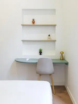 a desk in a room with a chair and shelves at Charme et modernite au coeur du Vieux Nice in Nice