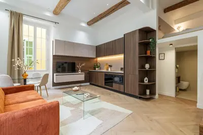 a living room with a couch and a table at Charme et modernite au coeur du Vieux Nice in Nice