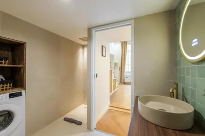 a bathroom with a sink and a washing machine at Charme et modernite au coeur du Vieux Nice in Nice