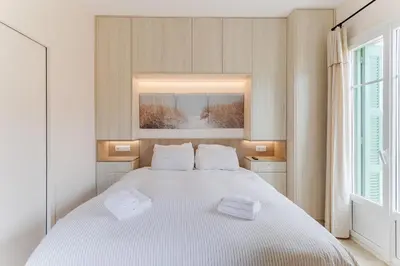 a bedroom with a white bed with two towels on it at COCO BEACH AP4476 by Riviera Holiday Homes in Nice