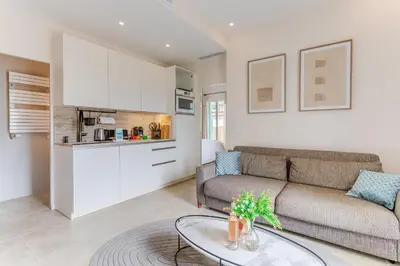 a living room with a couch and a table at COCO BEACH AP4476 by Riviera Holiday Homes in Nice