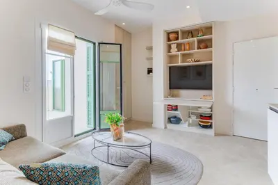 a living room with a couch and a table at COCO BEACH AP4476 by Riviera Holiday Homes in Nice