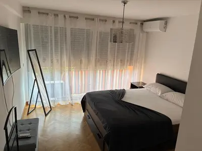 a bedroom with a bed and a large window at Nice vauban in Nice