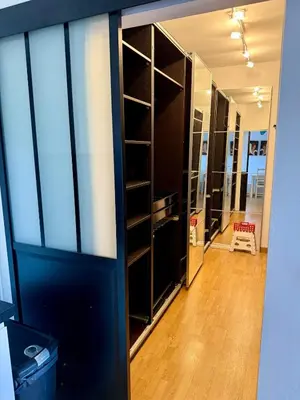 a room with a large closet with glass doors at Havre de paix proche de Nice in Aspremont