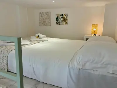 a bedroom with a large white bed with a lamp at Studio Dore Fshh in Nice