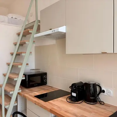 a kitchen with a counter with a microwave and a stove at Studio Dore Fshh in Nice