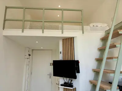a room with two bunk beds and a flat screen tv at Studio Dore Fshh in Nice