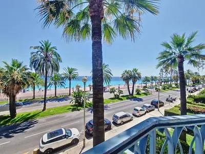 a view of a street with palm trees and cars at Nestor&Jeeves - PROMENADE DU SUD - Vue Mer in Nice