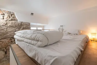 a bedroom with a large bed with a pillow on it at Etudiants port - 1pers, wifi, AC in Nice