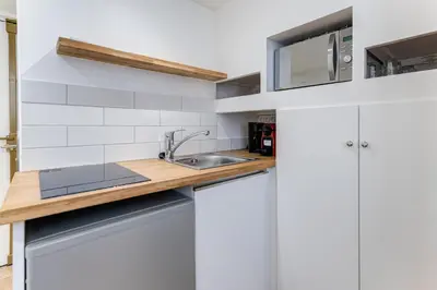 a kitchen with white cabinets and a sink at Etudiants port - 1pers, wifi, AC in Nice