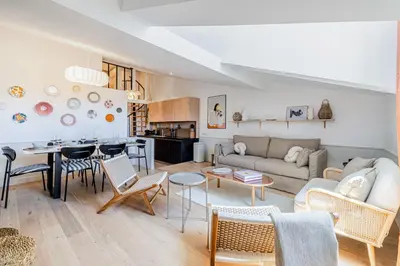 a living room with a couch and a table at Exceptional location, 2BR right on Place Massena, Newly Renovated in Nice