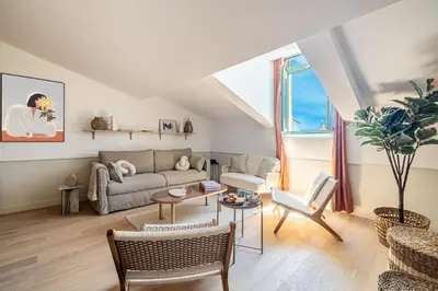 a living room with a couch and a table at Exceptional location, 2BR right on Place Massena, Newly Renovated in Nice
