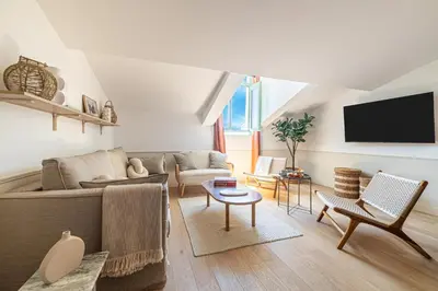 a living room with a couch and a tv at Exceptional location, 2BR right on Place Massena, Newly Renovated in Nice