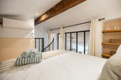 a bedroom with a bed and a large window at Exceptional location, 2BR right on Place Massena, Newly Renovated in Nice