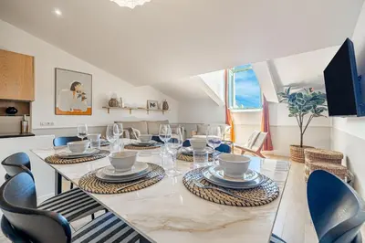 a dining room with a large table and chairs at Exceptional location, 2BR right on Place Massena, Newly Renovated in Nice