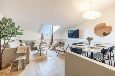 a living room with a table and a couch at Exceptional location, 2BR right on Place Massena, Newly Renovated in Nice