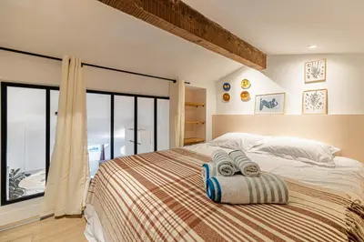 a bedroom with a bed with two towels on it at Exceptional location, 2BR right on Place Massena, Newly Renovated in Nice