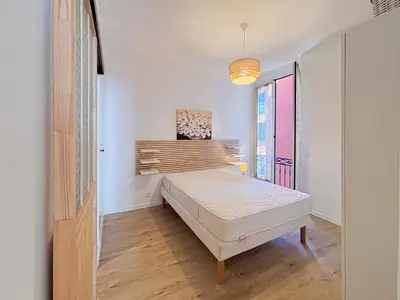 an open kitchen with white cabinets and a fireplace at Stalingrad - Wifi, AC, 4pers in Nice