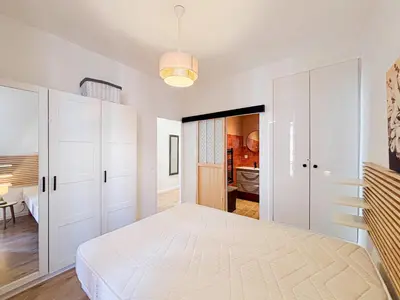 a kitchen with white cabinets and a washer and dryer at Stalingrad - Wifi, AC, 4pers in Nice