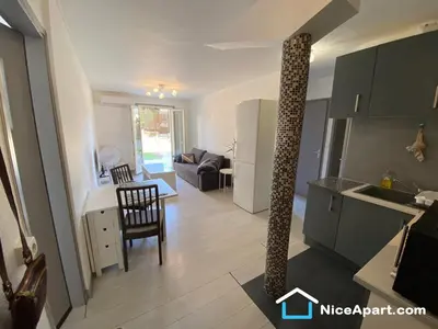 a kitchen and a living room with a pole at Nice hillside with 100 sqm private garden in Nice