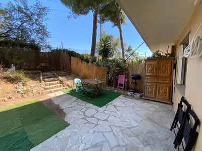 a patio with a table and a fence at Nice hillside with 100 sqm private garden in Nice