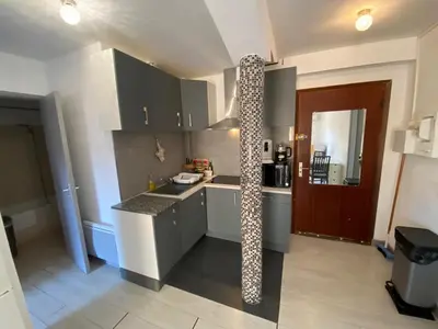 a kitchen with a long pole in the middle of it at Nice hillside with 100 sqm private garden in Nice