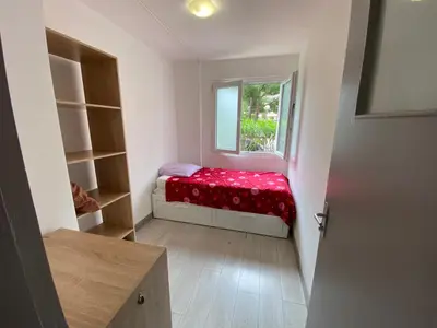 a small room with a bed and a window at Nice hillside with 100 sqm private garden in Nice
