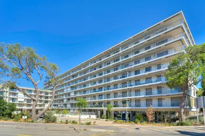 a large apartment building on a city street at Appartement Fleuri vue mer - Welkeys in Saint-Laurent-du-Var