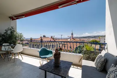 a balcony with a table and chairs and a view at Quiet & Open View - 1 Bdr Large Terrace in Nice