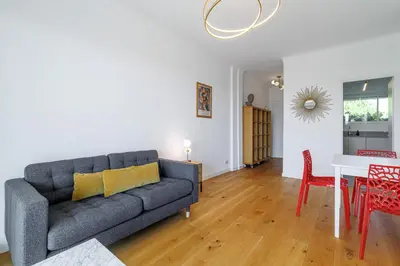 a living room with a couch and a table at Quiet & Open View - 1 Bdr Large Terrace in Nice