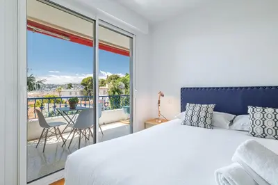 a bedroom with a bed and a balcony with a view at Quiet & Open View - 1 Bdr Large Terrace in Nice