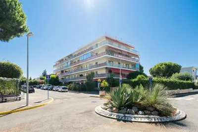 a large building on the side of a street at Studio Mimosas - Welkeys in Cagnes-sur-Mer