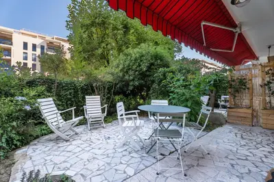 a patio with a table and chairs and a basketball hoop at Studio Mimosas - Welkeys in Cagnes-sur-Mer