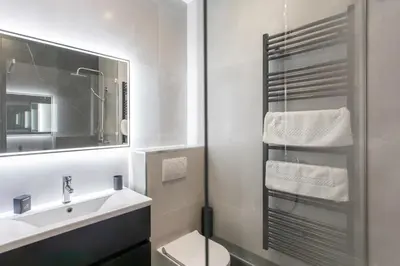 a bathroom with a sink and a toilet and a mirror at L4 Fayad 2BDR Hotel des Postes Central, Massena AC 2Balconies in Nice