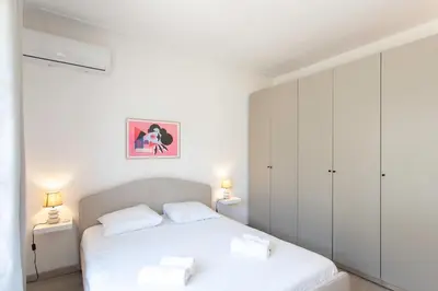 a bedroom with a white bed with two white pillows at L4 Fayad 2BDR Hotel des Postes Central, Massena AC 2Balconies in Nice