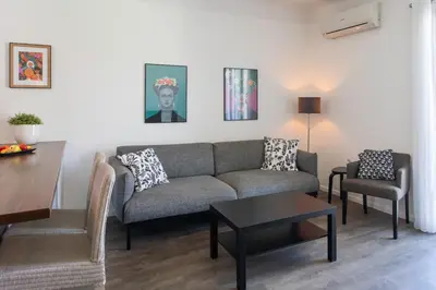 a living room with a couch and a table at L4 Fayad 2BDR Hotel des Postes Central, Massena AC 2Balconies in Nice