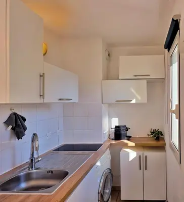 a small kitchen with a sink and a counter at Studio près mer et aéroport - Studio near sea and airport in Nice