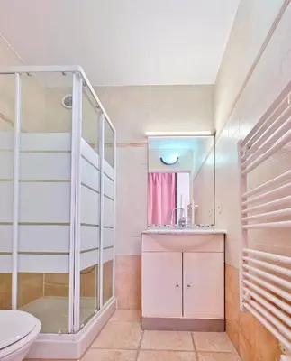 a bathroom with a toilet and a sink at Studio près mer et aéroport - Studio near sea and airport in Nice