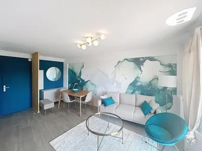 a living room with a couch and a table at Beautiful 4 rooms sea airport in Nice