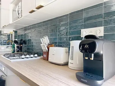 a coffee machine sitting on a counter in a kitchen at Beautiful 4 rooms sea airport in Nice