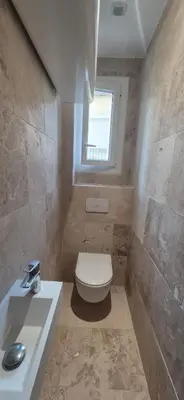 a bathroom with a toilet and a sink and a window at Arty & Chic à Nice in Nice