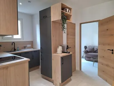 a kitchen with a refrigerator and a living room at Arty & Chic à Nice in Nice